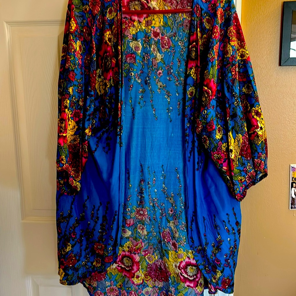 Brightly colored floral three quarter sleeve thigh length soft jacket